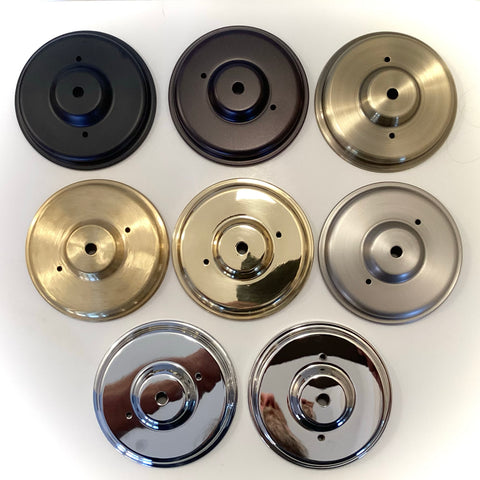 Assorted round metal ceiling canopies in multiple finishes—including black, oil-rubbed bronze, antique brass, polished brass, satin nickel, chrome, and polished nickel—displayed for lighting restoration at Vintporium.