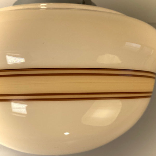 Close-up of hand-painted mocha stripe banding on opal milk glass schoolhouse shade