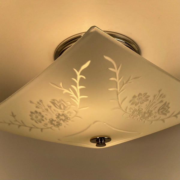Mid-century square frosted glass ceiling light lit, showing etched botanical pattern