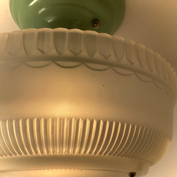 Detail view of vintage frosted ribbed glass shade showing pressed glass texture