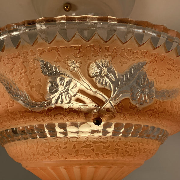 Close up of peach etched glass ceiling light showing textured glass surface