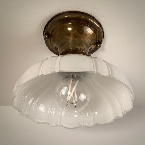 Brass flush mount ceiling light with scalloped milk glass shade front view