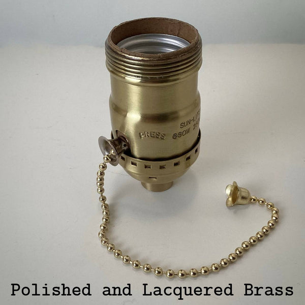 Polished and lacquered brass UNO pull-chain light socket with gold chain and acorn finial.