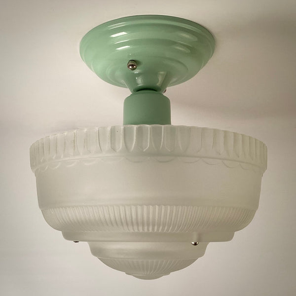 Art Deco semi-flush ceiling light unlit, highlighting frosted glass bowl and green metal canopy