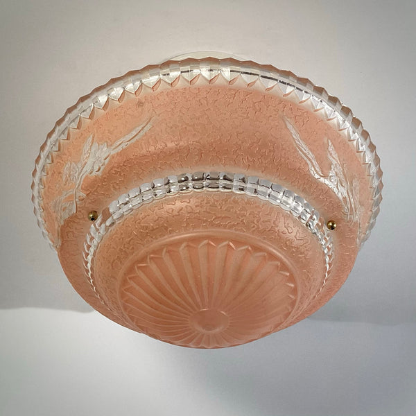Bottom view of peach etched glass ceiling light showing ribbed center diffuser