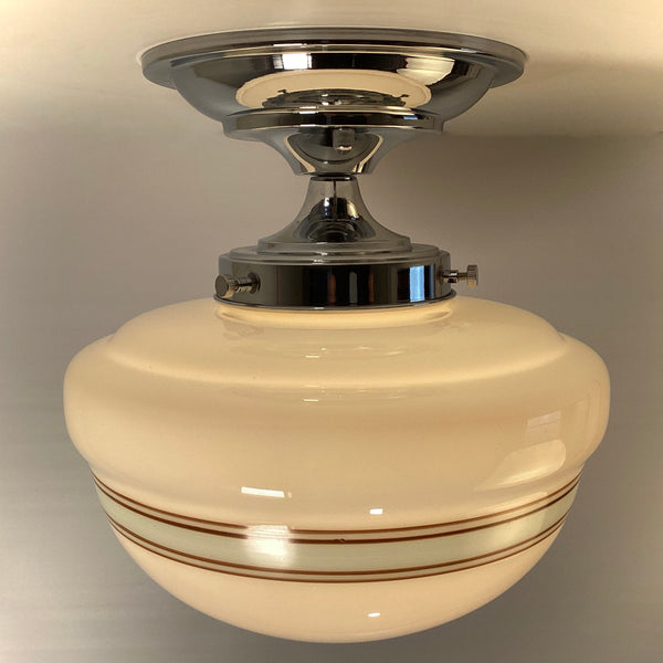 Profile view of polished chrome semi-flush mount light hardware with striped glass shade detail.