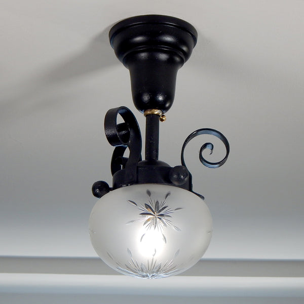 Approximately from the 1900s to the 1920s, this antique hand-crafted iron ceiling light fixture offers a superb blend of artistic impact and practicality. The semi-flush mount design of the fixture ensures that the fixture remains close enough to the ceiling to maintain an intimate ambiance while providing ample illumination to light any room with a gentle, inviting glow. Available at www.vintporium.com