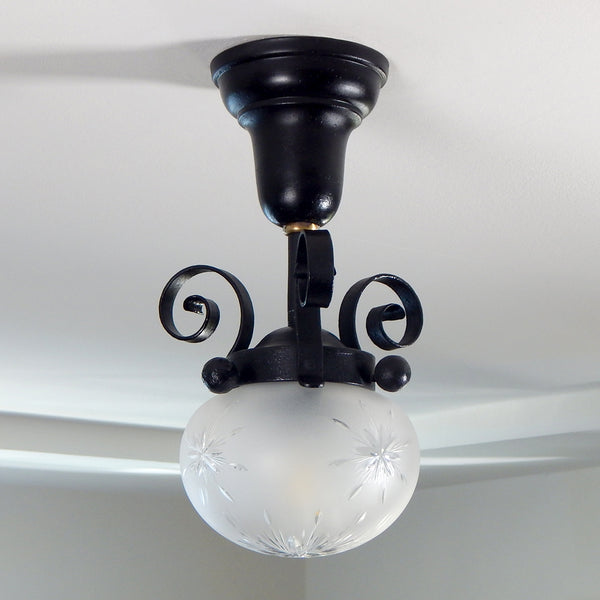 Approximately from the 1900s to the 1920s, this antique hand-crafted iron ceiling light fixture offers a superb blend of artistic impact and practicality. The semi-flush mount design of the fixture ensures that the fixture remains close enough to the ceiling to maintain an intimate ambiance while providing ample illumination to light any room with a gentle, inviting glow. Available at www.vintporium.com