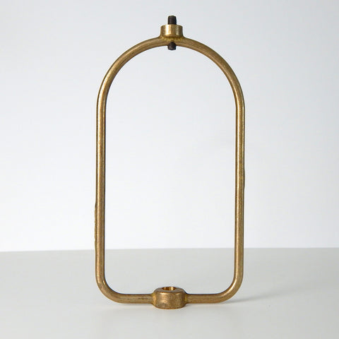 This harp is the most versatile center-post shade holder available on the market. It is designed to fit glass shades with either a 1/8 IPS center hole or a smaller 1/4-27 thread. The harp can be used for boudoir lamps or ceiling center-post light fixtures. The harp supports the shade and usually mounts under the socket and socket cup to the ceiling canopy or lamp base. The harp is unfinished brass. Available at www.vintporium