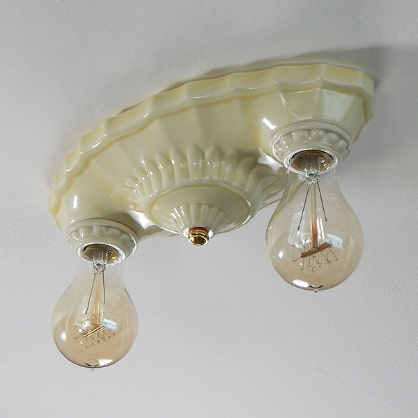 This beautiful antique ceiling light fixture is made of uranium glass glazed porcelain and features a classic Art Deco design. The fixture has been restored and features new wiring, sockets, etc. It has been cleaned and detailed and is ready to install. Available at www.vintporium.com