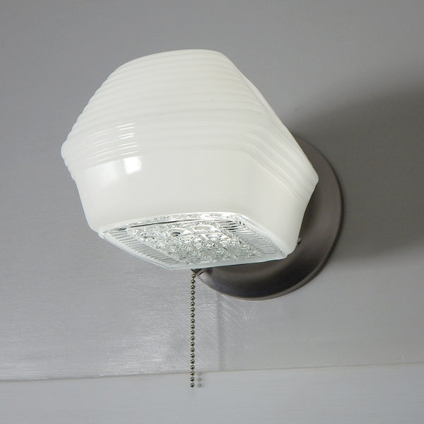 Post-War Era Pull Chain Equipped Sconce. Vintage Glass Shade. New Fixture Base. The fixture features a vintage enameled glass shade and a new pull chain fixture. The light comes with installation hardware, making it convenient to install. Available at www.vintporium.com