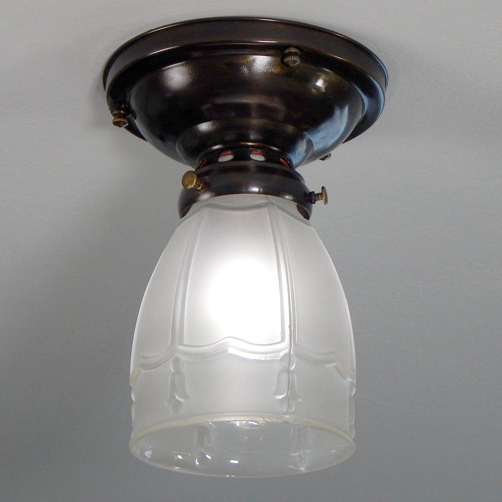 The antique flush mount ceiling light features a customized mounting bracket for installation with modern electrical boxes, new wires, wire sheathing, and a porcelain socket. The fixture has been cleaned, detailed, and including mounting hardware for convenient installation. Available at www.vintporium.com