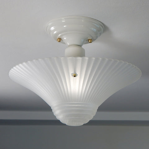 The semi-flush triple-beaded chain ceiling light fixture emerged with its earliest iterations in the 1920s through the 1940s. Triple-beaded chain fixtures of this period featured bold patterns and almost always had enameled finishes in pinks, blues, greens, whites, or bisque colors. The trend continued into the 1960s with less heavy-looking glass shades and silk-screened enameled finishes instead of the hand-painted enameled finish. Available at www.vintporium.com