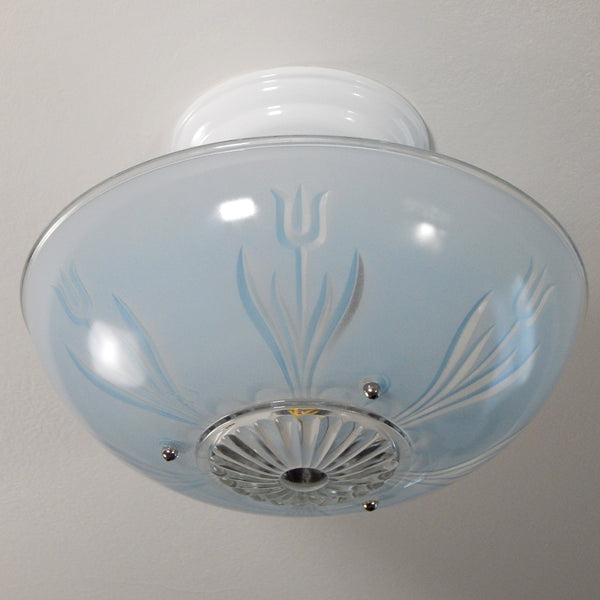 The semi-flush triple-beaded chain ceiling light fixture emerged with its earliest iterations in the 1920s through the 1940s. The beaded chain fixtures of this period featured bold patterns and almost always had enameled finishes in pinks, blues, greens, whites, or bisque colors. The trend continued into the 1960s with less heavy-looking glass shades and silk-screened finishes instead of the hand-painted enameled finish. Available at www.vintporium.com