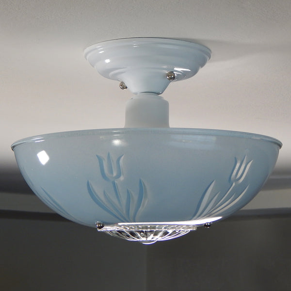 The semi-flush triple-beaded chain ceiling light fixture emerged with its earliest iterations in the 1920s through the 1940s. The beaded chain fixtures of this period featured bold patterns and almost always had enameled finishes in pinks, blues, greens, whites, or bisque colors. The trend continued into the 1960s with less heavy-looking glass shades and silk-screened finishes instead of the hand-painted enameled finish. Available at www.vintporium.com