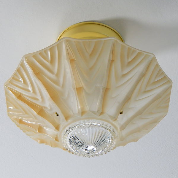 Interior designs of 1940s America were filled with a fascination with exotic tropical destinations and fueled with a sense of escapism, especially following World War II. The tropical-inspired ceiling light fixture features new wiring, porcelain sockets, etc. The fixture has been cleaned and detailed and comes with installation hardware, making for a convenient installation. Available at www.vintporium.com