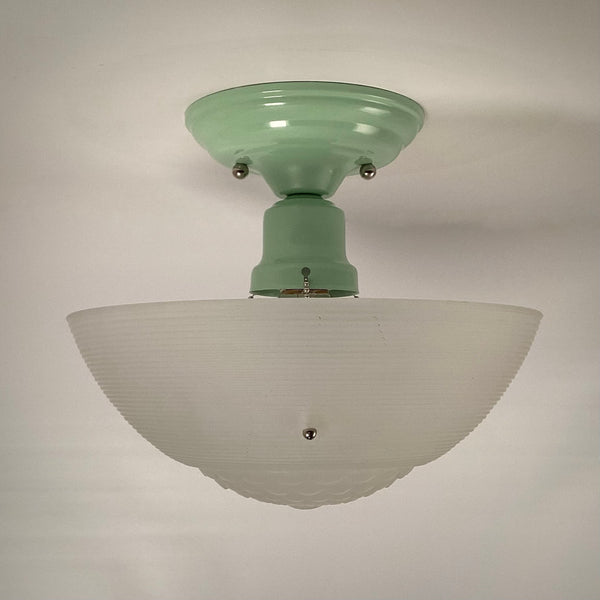Restored jadeite-green ceiling fixture with frosted ribbed glass shade, light turned off