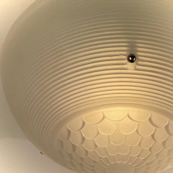 Jadeite-green vintage ceiling light with warm glowing ribbed glass shade.