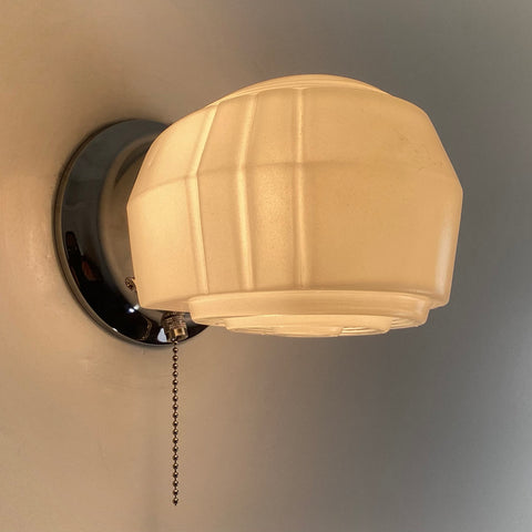 Post-War Era Pull Chain Equipped Sconce. Vintage Glass Shade. New Fixture Base. The sconce features a vintage enameled glass shade and a new pull chain fixture. The light comes with installation hardware, making it convenient to install. Available at www.vintporium.com