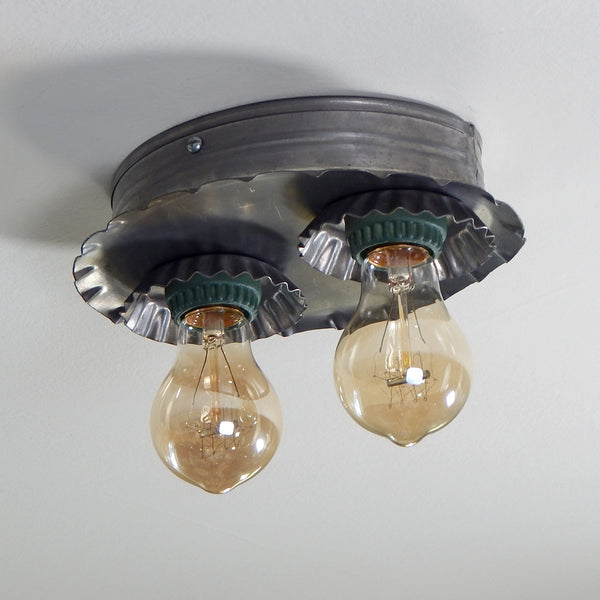 A vintage tin flush mount ceiling light that screams Americana. The light has been renovated with new sockets and wiring. The fixture has been cleaned and includes installation hardware making it easy and convenient to install. Available at www.vintporium.com