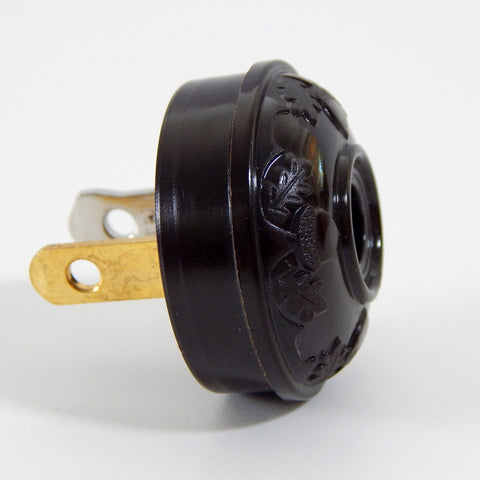 Early electric replica embossed acorn and oak leaf motif bakelite plug. The plug features an insulator and polarized prongs.  Available at www.vintporium.com