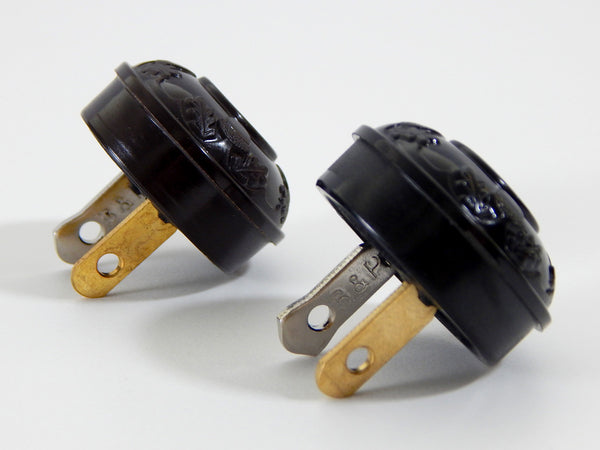 Early electric replica embossed acorn and oak leaf motif bakelite plug. The plug features an insulator and polarized prongs.  Available at www.vintporium.com