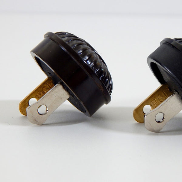 Early electric replica embossed ribbed motif bakelite plug. The plug features an insulator and polarized prongs.  Available at www.vintporium.com