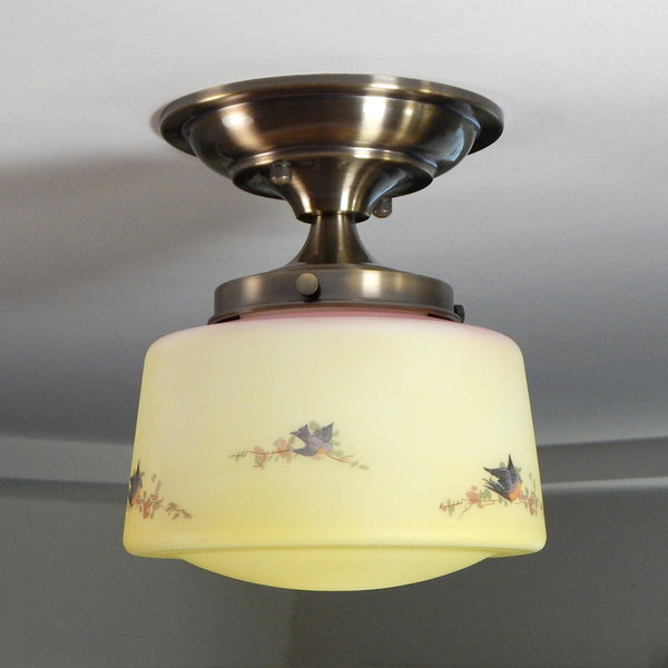 Delightfully painted yellow, and pink ceiling light adorned with robins and floral branches. The antique brass finish fixture is new and U.L.-listed. The light fixture comes with all the necessary hardware for easy installation. Available at www.vintporium.com